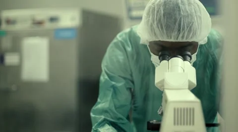 Man at work with microscope in biotechnology lab Stock Footage 11126360