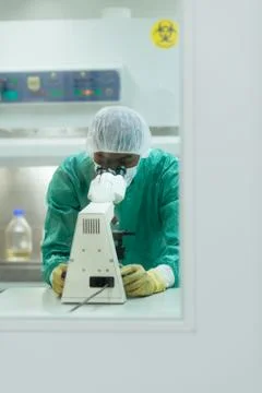 Man at work with microscope in biotechnology lab Stock Photos