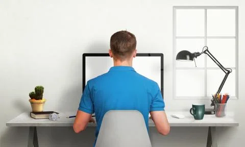 Man work on office computer with isolated screen for mockup. Stock Photos