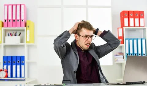 Man work online laptop computer in office, business failure concept Stock Photos