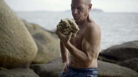 Man to work out, with a big stone, Stock Footage 122997977