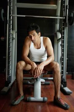 Man on work out equipment Stock Photos