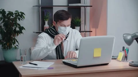 A man at work says over the link that he has a high temperature. Stock Footage 145167071