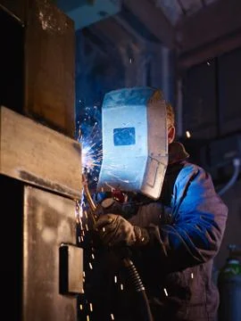 Man at work as welder in heavy industry Stock Photos