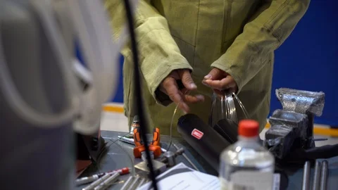 Man at workbench folding piece of welding wire semi-automatic machine close up Video stock 126356088