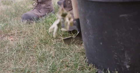 Man in workboots cutting into sod - close up Stock Footage 81650752