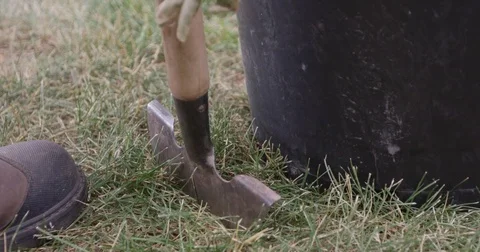 Man in workboots edging sod for new tree - slow motion Video stock 81650512