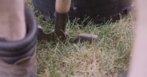 Man in workboots edging sod - slow motion close up Stock Footage 81650164