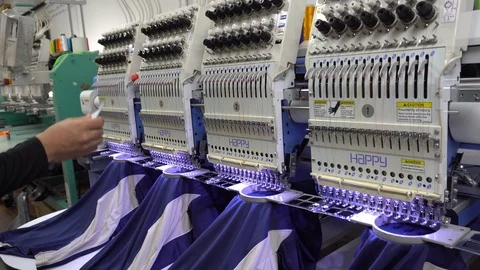 A Man worker are operate Embroidery Machine at Garment Manufacturers Video stock 106791897