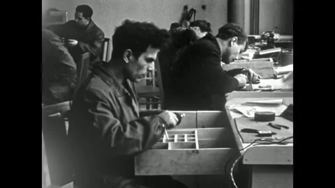 Man worker assembles parts at bench in Industrial workshop. Focused on precision Stock Footage 327599863