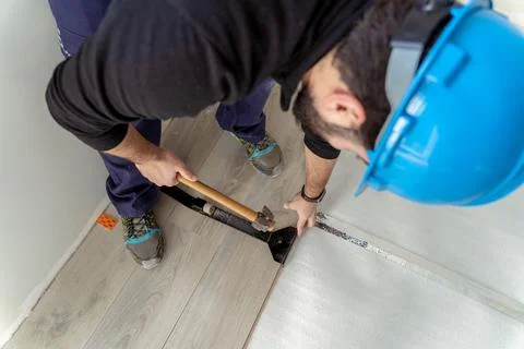 Man worker assembling laminate flooring. Stock Photos