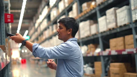 Man worker checking products with barcode scanner in warehouse. Stock Footage 233277549