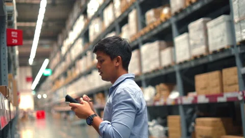 Man worker checking products with barcode scanner in warehouse. Stock Footage 233278193