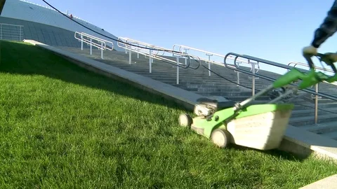 The man the worker cuts the grass on a lawn Видео 80410557