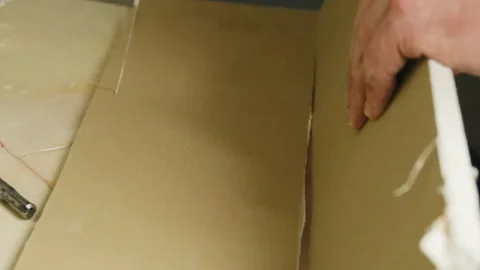 Man worker cuts gypsum panel with knife on table closeup Stock Footage 304408110