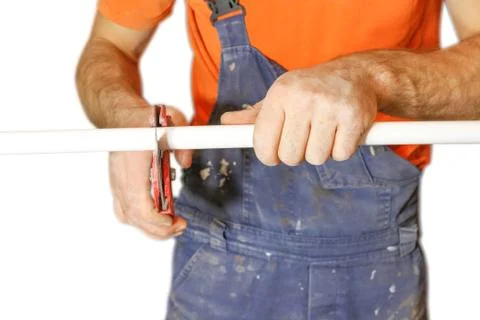 Man worker cuts off a piece of polypropylene pipes. Isolated on white backg.. 스톡 사진
