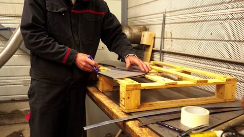A man worker drawing lines on a stainless steel piece in a factory.

Un Vidéo 108458641