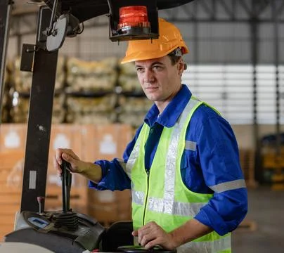 Man worker at forklift driver happy working Stock Photos