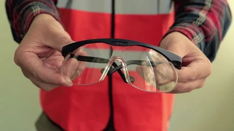Man worker give to the camera protective working glasses. Stock-Footage 107426094