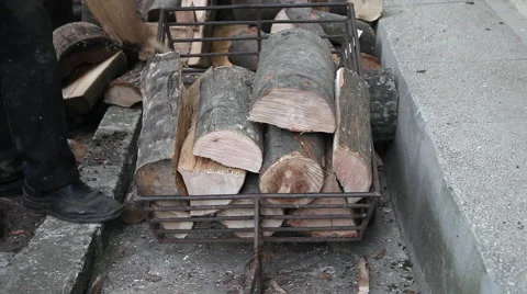 Man, worker loading cart with firewood, wood logs, stumps, winter supplies Stock Footage 40670318