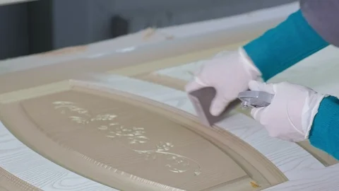 Man, the worker makes the effect of aging doors. production of interior doors Stock Footage 98013935