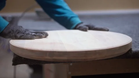 Man worker makes a round table in the carpentry Stock Footage 120694464