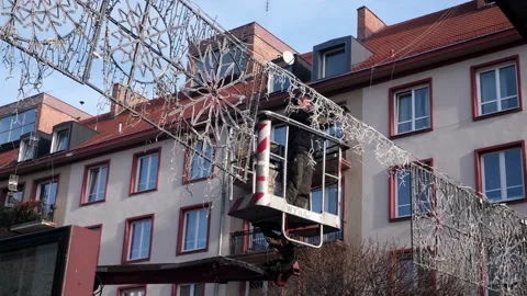 Man worker mount Christmas decorations at city fair. Preparation for New Year. Video stock 132771853