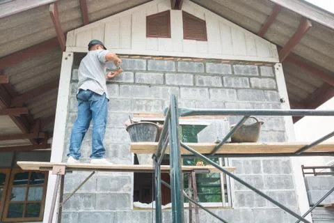 Man Worker or Laborer working with Cement Block Stock Photos