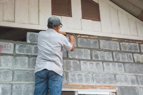 Man Worker or Laborer working with Cement Block Stock Photos
