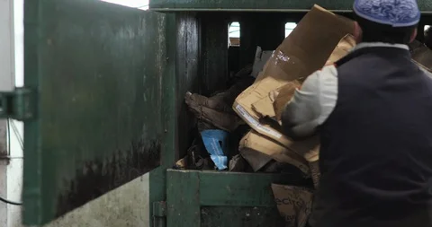 Man worker sorting putting paper cardboard garbage in container and closing it. Stock Footage 120122797