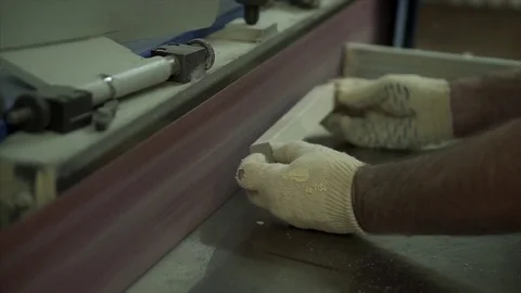 A man worker stands by the machine. The worker trains the part. Works with wood  Stock Footage 84043078