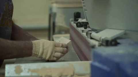 A man worker stands by the machine. The worker trains the part. Works with wood  Stock Footage 84043279