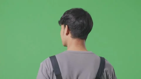 Man Worker Walking And Looking Around In The Green Screen Background Studio Stock Footage 253467193