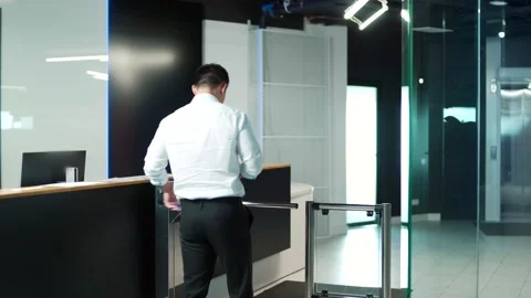 Man worker walks through a Automatic security turnstile station in office.  Stock Footage 218231711
