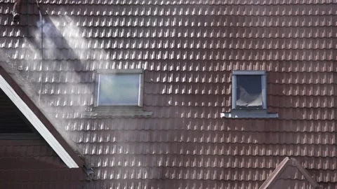 Man worker washing tilted stone roof shingles with water pressure washer. Video stock 147339019