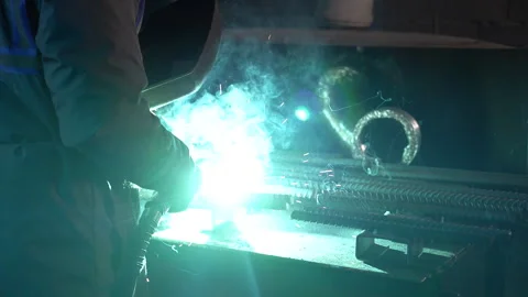Man worker welding metal with a arc welding machine Stock Footage 315633405