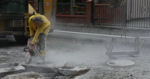 Man Worker in Yellow Workwear Close Up is Grinding The Blocks of Concrete by Stock Footage 54336802