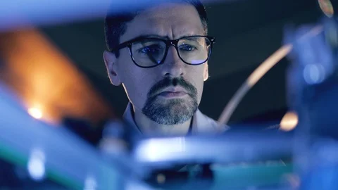 Man Working With A 3D Printer at 3d printing lab. Male specialist in glasses is Video stock 124203927