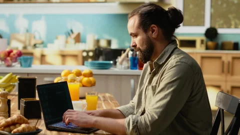 Man working with AI-powered application on laptop at home Stock Footage 330441819