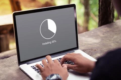 Man working and Installing update with circle load percentage waiting indicator  Stock Photos