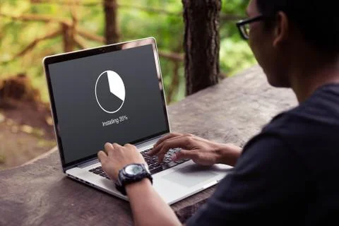 Man working and Installing update with circle load percentage waiting indicator  Stock Photos