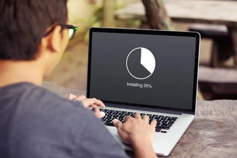 Man working and Installing update with circle load percentage waiting indicator  Stock Photos