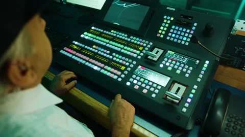 A man working and pressing the button in a television studio. Over the shoulder Video stock 199221740