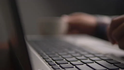Man working and typing on laptop Stock Footage 134304328