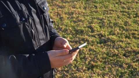 Man working and using his mobile phone outdoors Stock Footage 125777035