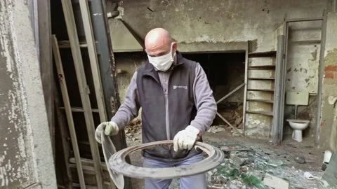 Man Working and Walking at Ruins Of Abandoned Building While Wears Mask Stock Footage 143190227