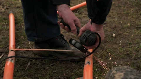 A man is working on an angle grinder Stock Footage 237959415