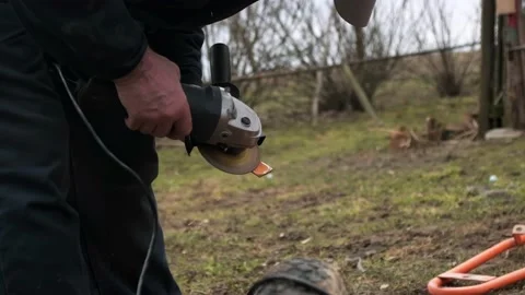 A man is working on an angle grinder Stock Footage 237959478