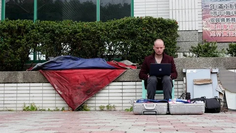 Man working on apple computer, outside station- Taidong, Taiwan - March 2018 Stock Footage 96065027