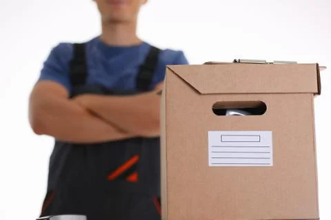Man in working apron bringing parcel in cardboard Stock Photos